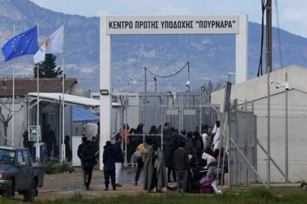 Migrants stand outside of Pournara migrant reception center Cyprus 768x5111 1 601x400 9RtTMc